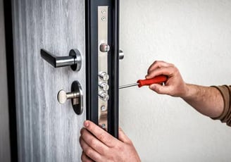 a man is fixing a door handle on a door