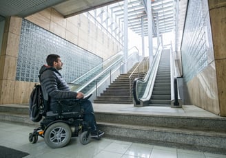 Man in Powerchair Looks Up at Inaccessible Steps