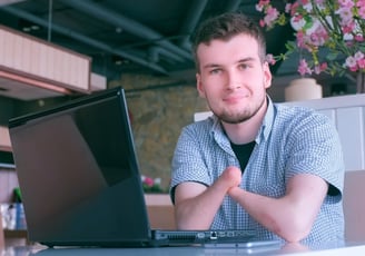 Photo of a worker with a physical disability working at his laptop