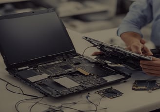 a man is holding a laptop computer and a laptop