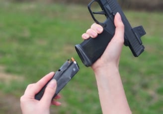 Women reloading defensive firearm.