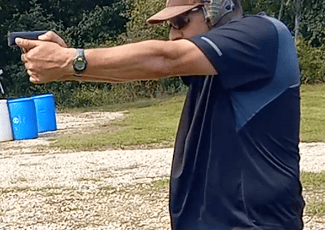 Man using self-defense firearm on range.
