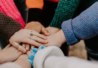 a team of people holding hands together in solidarity