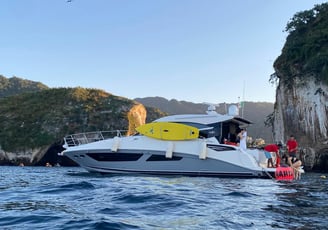 a boat with a yellow surfboard on the water