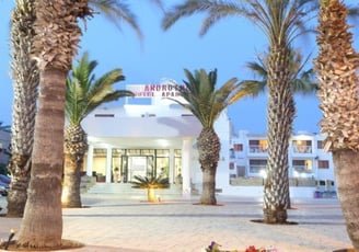 a hotel with palm trees in front in Ayia Napa