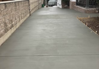 fresh laid cement for a new driveway installation.