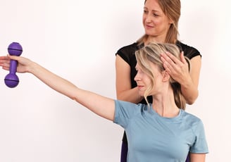 a woman is holding a purple object in her hand