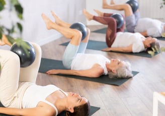 a woman is doing a yoga pose on a yoga mat