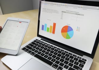 A laptop with data chart in screen.