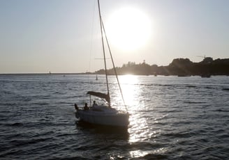 The sailboat Monark sailing on the Douro River at sunset