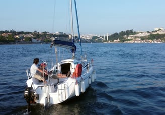 Our sailboat Monark cruising on the Douro River on a sunny day