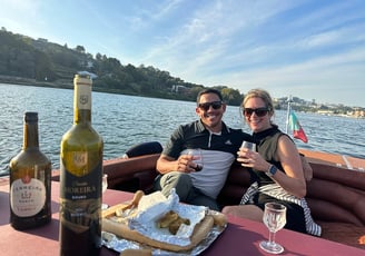 A couple enjoying wine and snacks on the James Bond–style speedboat Eskrok