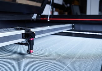 a machine is cutting a piece of metal with a laser laser machine