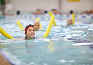 young child learning to swim