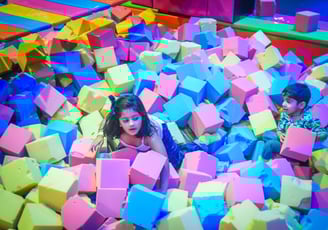 a child's play area with a large pile of colorful blocks