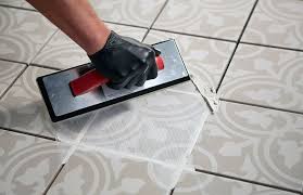 a person installing new grout to a tile floor