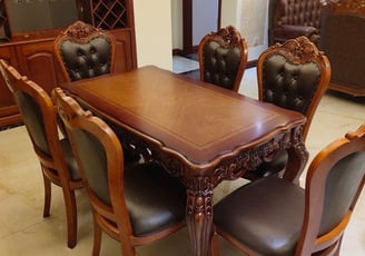 a dining room table with a wooden table and chairs