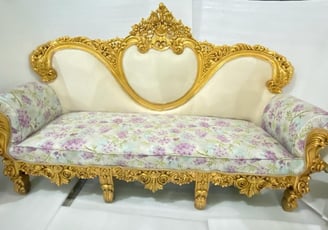 a couch with a gold leafed pattern on it