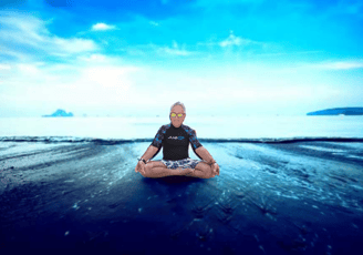 Philippe sitting in meditation on a beach