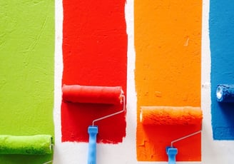 rows of paint with rollers in different colours