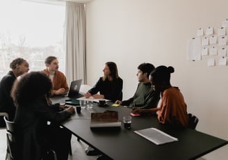 a group of people sitting around a table