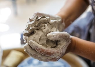 Uneven ball of clay in hands