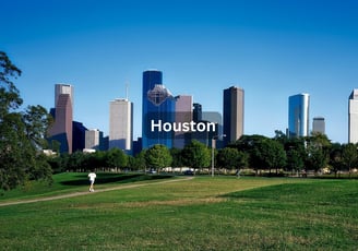 Downtown Houston Texas on a bright sunny day with green grass