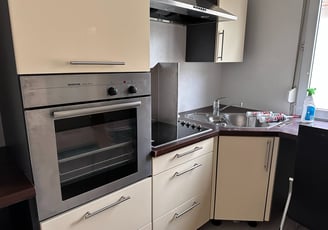 a kitchen with a stove top oven and a sink