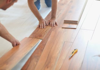 Professionals are installing click type floating laminate flooring.