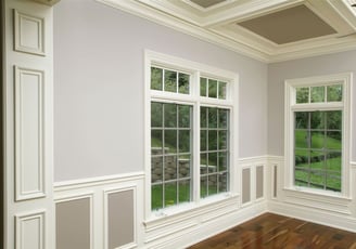 Millwork on windows, boxes on the walls, elegant baseboards and beautiful crown molding.