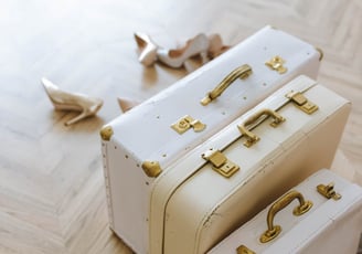 a pair of white suitcases sitting on a wooden floor