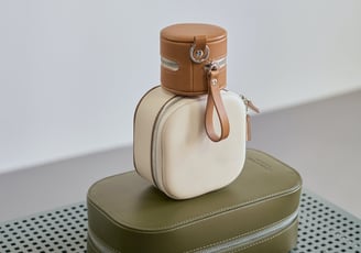 a suitcase with a bottle of wine on top of it