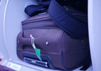 a suitcase with luggage on it and a suitcase on the ground