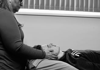 Woman giving Reiki to man
