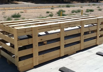 an open crate with plywood slats