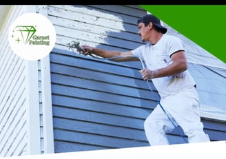 Garnet Painting team working on exterior house painting with company logo visible”