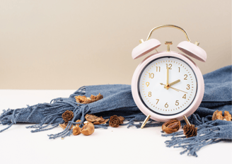 a pink alarm clock sitting on a table