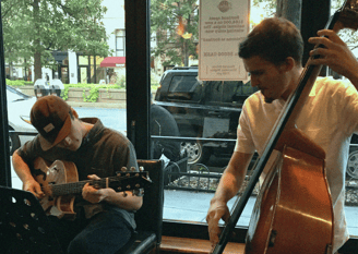 a guitarist and bassist playing in a restaurant