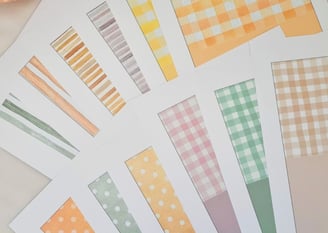Assorted card pattern swatches on white paper featuring stripes, polka dots, and checkered designs