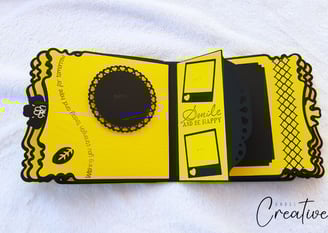 Decorative album page featuring yellow and black design elements. Includes photo frames, intricate b