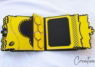 Yellow and black album page with honeycomb shapes and decorative borders. Includes a space for photo