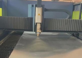 laser machine cutting a metal sheet for sink