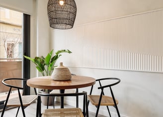 Elegant dining area with bespoke relief wall panels and contemporary furniture and sleek design