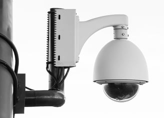 a camera mounted to a pole with a camera attached to it
