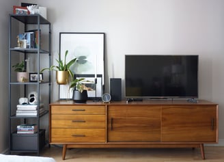 A mid-century modern vanity with TV and stylish décor.