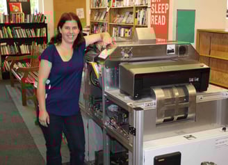 A woman in a bookstore shows how the Espresso book machine works.
