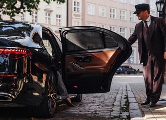 a man in a suit and hat walking down the street