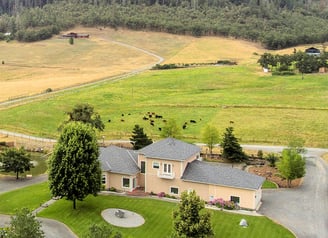 a large house with a large yard and a large field