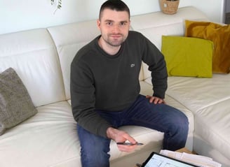 Ein Energieberater, der auf einer Couch sitzt und eine Energieberatung durchführt.