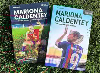 two books on the grass with a soccer player